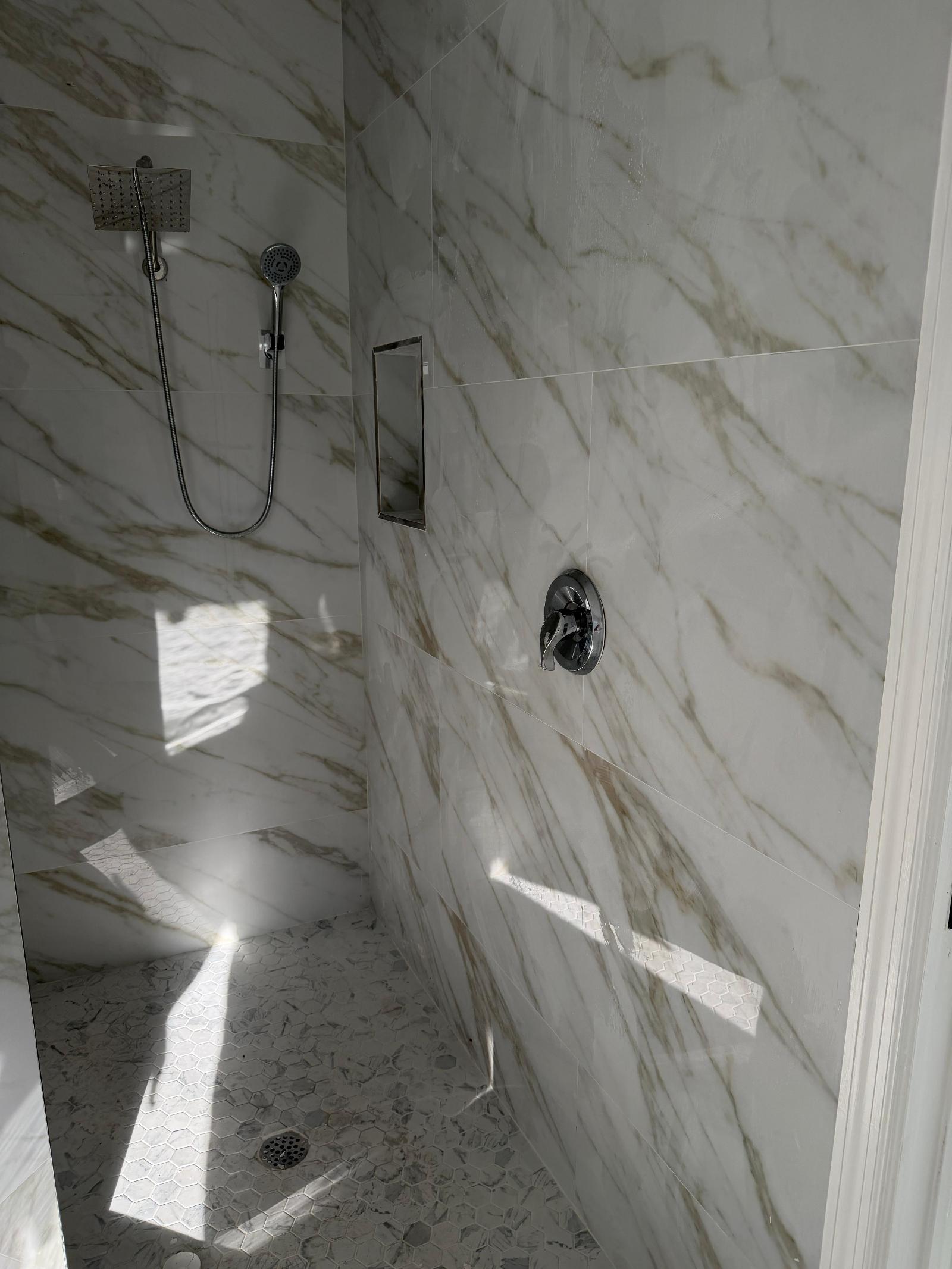 Ducha revestida en mármol PVC blanco con piso hexagonal